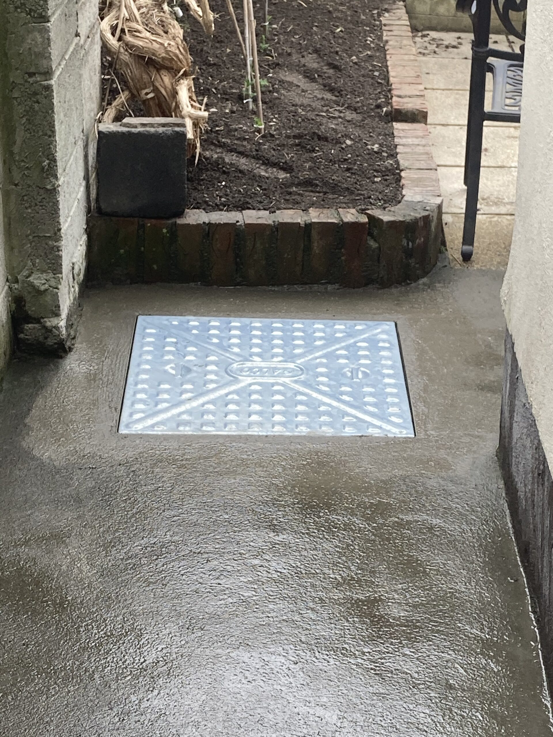 A1 Drains team replacing a manhole cover - providing reliable manhole cover replacement services.