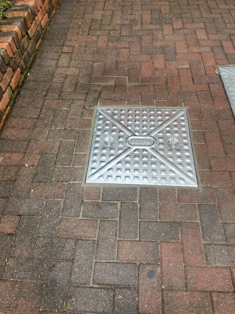 A manhole cover supporting texts for manhole cover replacement services.